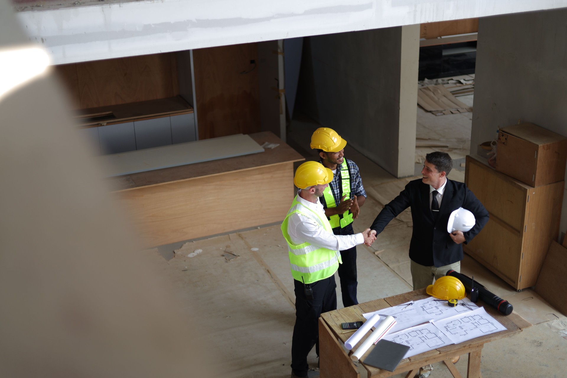 Businessman, contractors and engineers working at construction sites are construction inspector and supervise the work according to plans. Coworker cooperation and teamwork to ensure workplace safety.